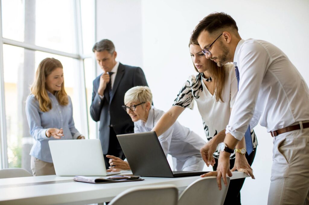 Senior-businesswoman-working-together-with-young-business-people-office - Rupetta Consultancy Rupetta Consultancy - Business People