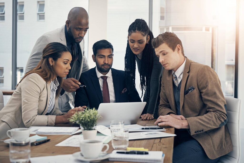 Strategy-experts-shot-group-young-businesspeople-using-laptop-together-during-meeting-modern-office - Rupetta Consultancy Rupetta Consultancy - Office Discussion